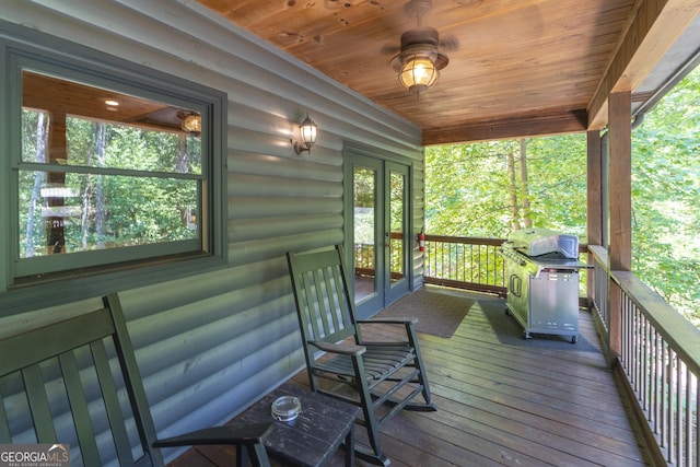 deck featuring a porch and a grill