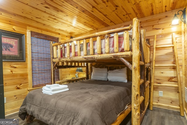 bedroom with wooden ceiling, wood finished floors, and wooden walls