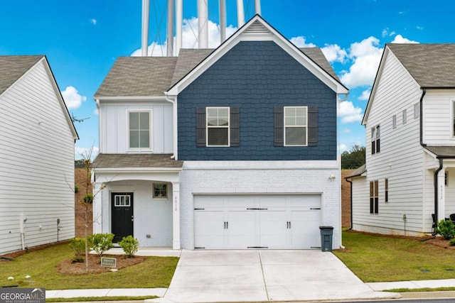 view of front of home with a garage, driveway, a front lawn, and brick siding