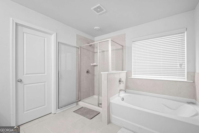 full bathroom featuring visible vents, a bath, tile patterned flooring, and a shower stall