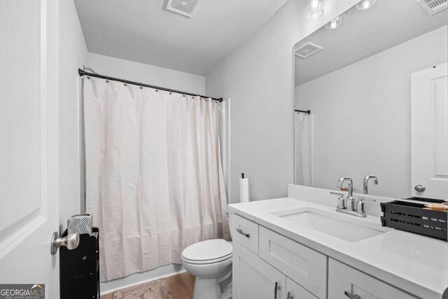 full bath featuring visible vents, wood finished floors, and toilet
