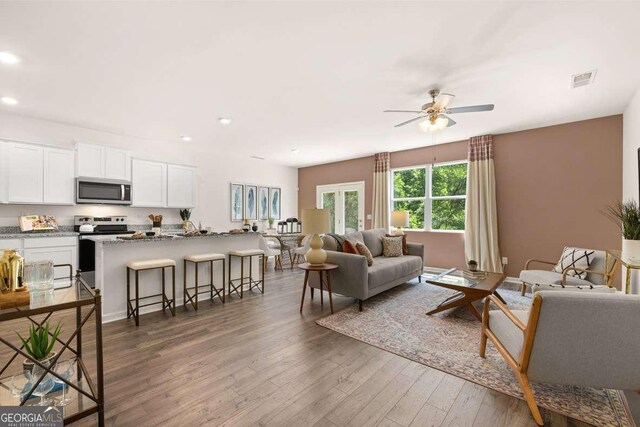309 Elgin Dr, Lawrenceville, GA 30045 - living area featuring wood finished floors, ceiling fan, recessed lighting, and visible vents