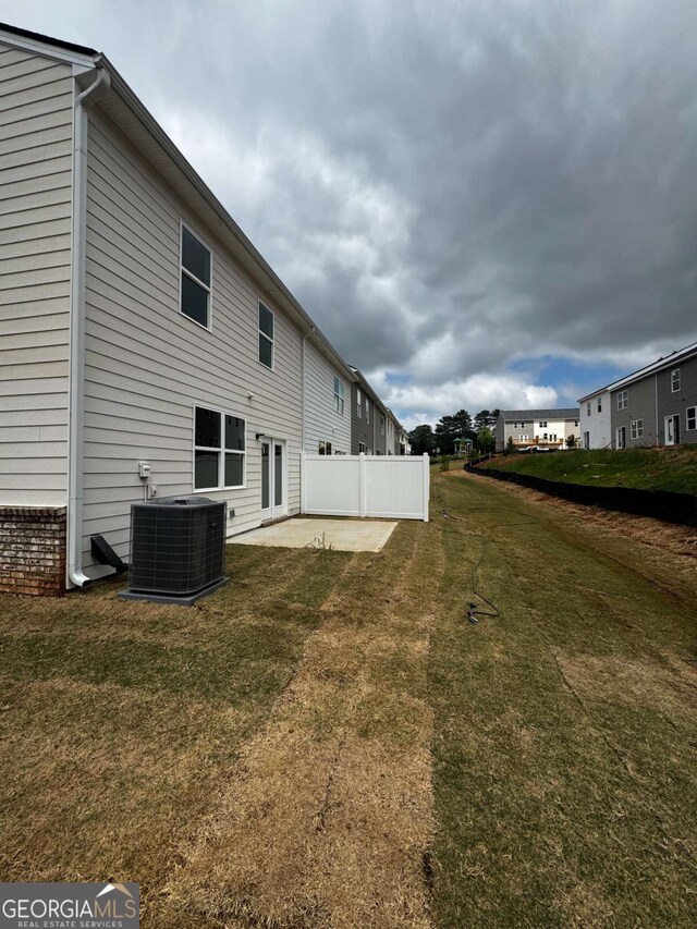 309 Elgin Dr, Lawrenceville, GA 30045 - rear view of property with cooling unit, a lawn, and a patio