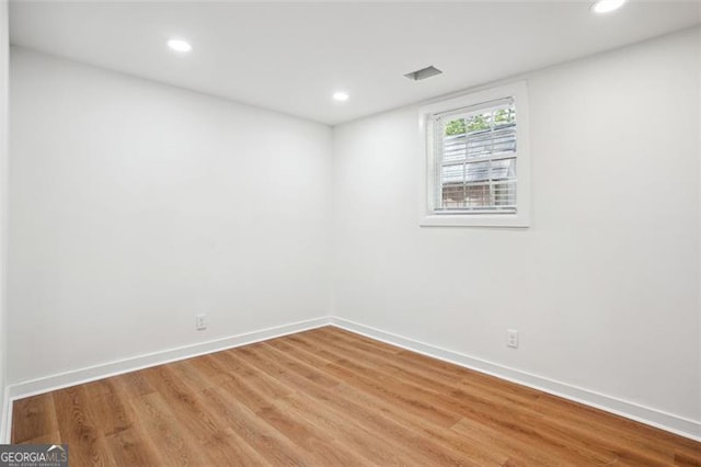 unfurnished room featuring baseboards, recessed lighting, and light wood-style flooring