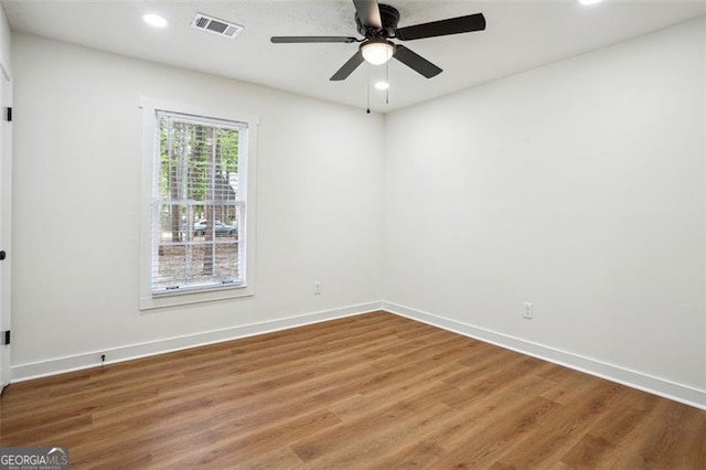 empty room with recessed lighting, wood finished floors, ceiling fan, baseboards, and visible vents