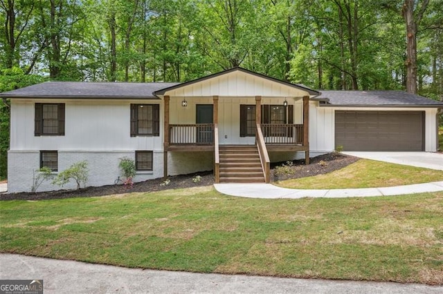 ranch-style house featuring driveway, covered porch, a front yard, stairway, and a garage