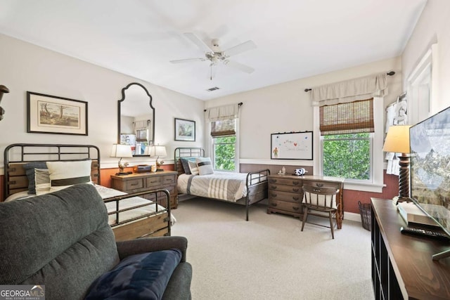 carpeted bedroom with visible vents and a ceiling fan