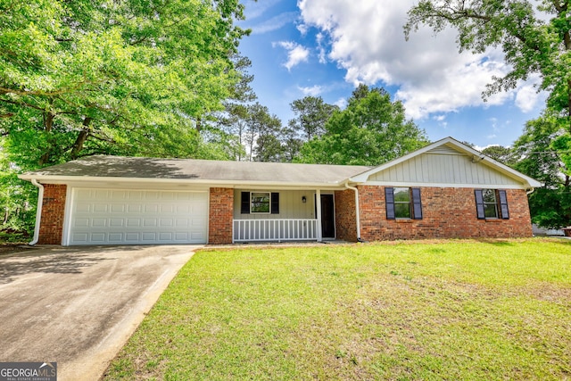 2931 Randolph Ct NE, Conyers, GA 30012 - single story home with a front yard, brick siding, concrete driveway, an attached garage, and a porch