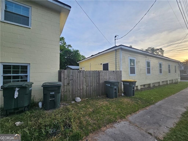 view of side of home featuring fence