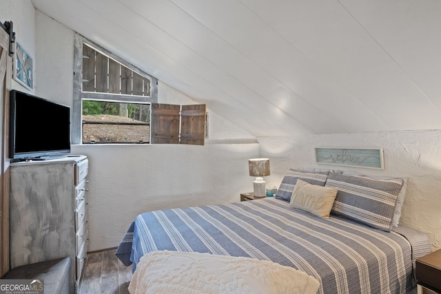43 Cowan Ct, Mansfield, GA 30055 - bedroom with lofted ceiling, wood finished floors, and a textured wall