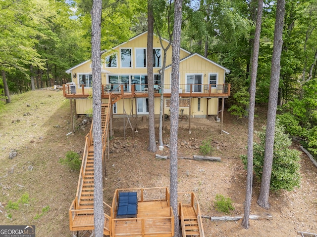 43 Cowan Ct, Mansfield, GA 30055 - back of house with stairway, a deck, and view of wooded area