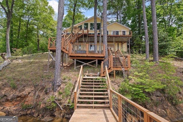 43 Cowan Ct, Mansfield, GA 30055 - rear view of house featuring stairs, a wooden deck, and view of wooded area