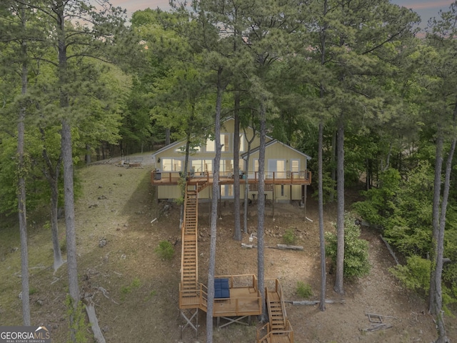 43 Cowan Ct, Mansfield, GA 30055 - back of house with stairs, a wooden deck, and a wooded view