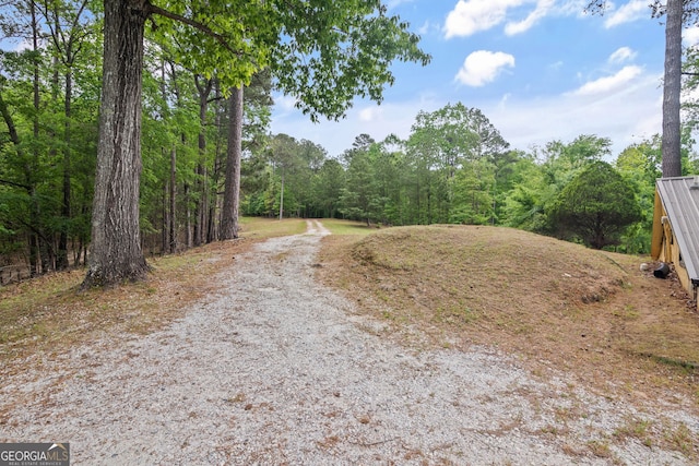 43 Cowan Ct, Mansfield, GA 30055 - view of dirt / gravel road with a wooded view