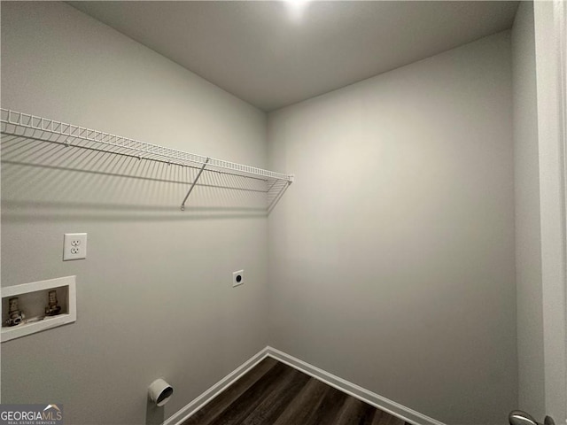 clothes washing area featuring laundry area, washer hookup, dark wood finished floors, baseboards, and hookup for an electric dryer