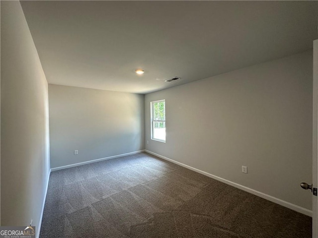 empty room with visible vents, recessed lighting, baseboards, and dark colored carpet