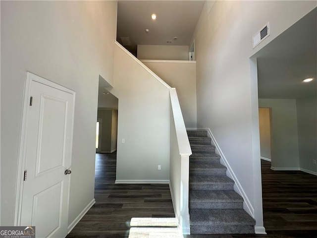 staircase with visible vents, recessed lighting, baseboards, and wood finished floors
