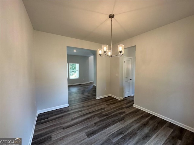 unfurnished dining area featuring baseboards, a chandelier, and dark wood-type flooring
