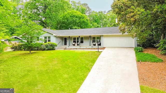 ranch-style house featuring a porch, a front lawn, an attached garage, and concrete driveway