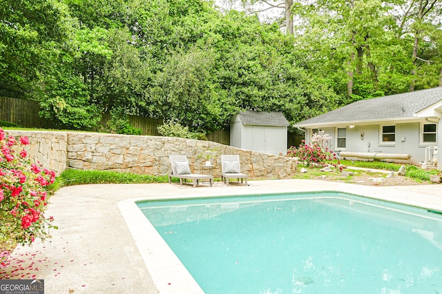 view of pool featuring an outdoor structure, fence, a patio, a shed, and a fenced in pool