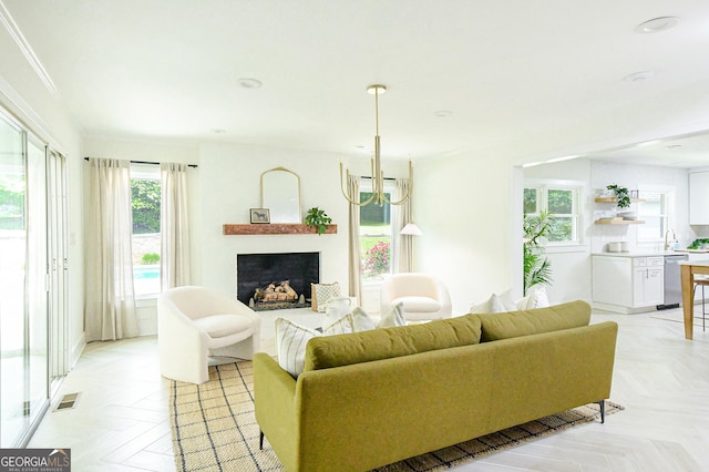 living room featuring visible vents, recessed lighting, a fireplace, and an inviting chandelier