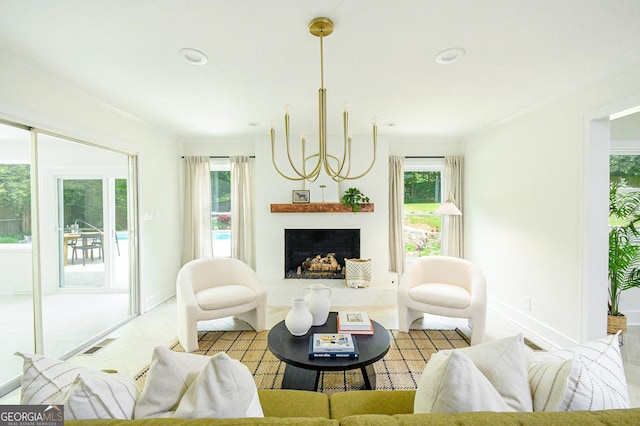 living area with crown molding, a notable chandelier, visible vents, and plenty of natural light