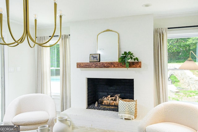 living area featuring a brick fireplace and crown molding