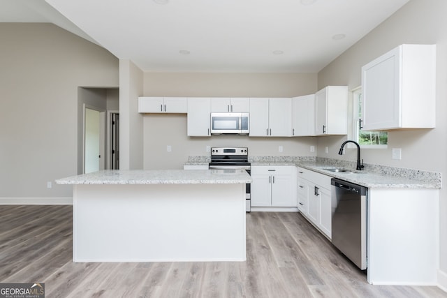 516 Branch St, Cedartown, GA 30125 - kitchen featuring a sink, stainless steel appliances, light wood-style floors, a center island, and white cabinetry