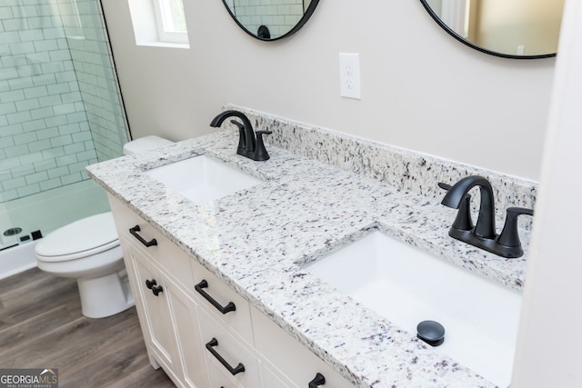 516 Branch St, Cedartown, GA 30125 - bathroom with wood finished floors, a shower stall, toilet, and a sink