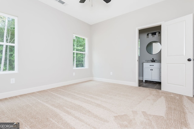 516 Branch St, Cedartown, GA 30125 - unfurnished bedroom featuring connected bathroom, carpet, baseboards, visible vents, and a ceiling fan