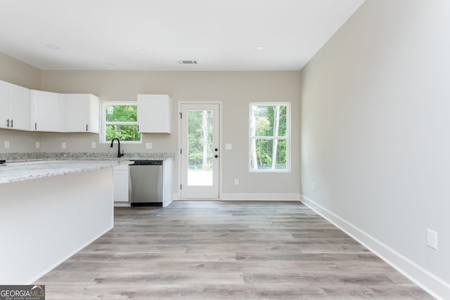 516 Branch St, Cedartown, GA 30125 - kitchen featuring light stone countertops, light wood-style floors, visible vents, stainless steel dishwasher, and white cabinets