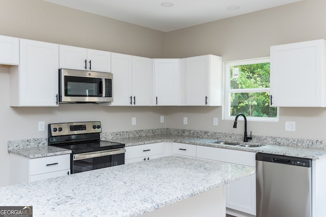 516 Branch St, Cedartown, GA 30125 - kitchen with light stone countertops, a sink, white cabinets, and stainless steel appliances