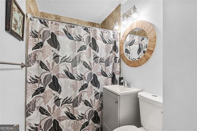 bathroom with vanity, toilet, and curtained shower