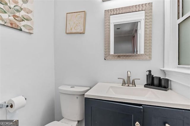bathroom with toilet and vanity