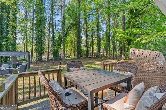 wooden deck featuring outdoor dining space