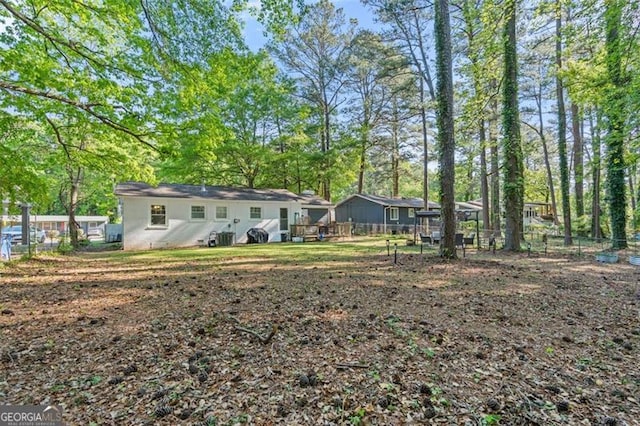 back of house featuring fence