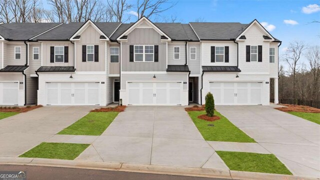 322 Sound Cir Unit 118, Stockbridge, GA 30281 - view of front of house featuring a standing seam roof, driveway, and an attached garage