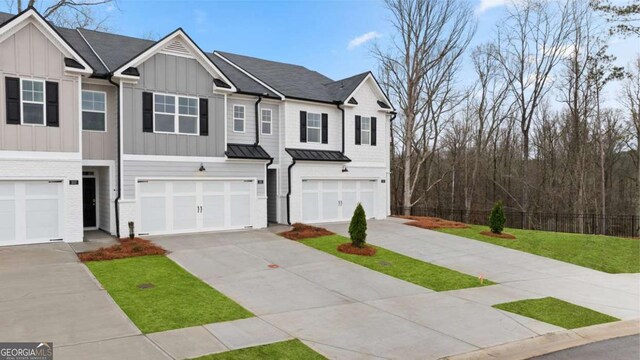 322 Sound Cir Unit 118, Stockbridge, GA 30281 - view of front of home featuring a garage, a standing seam roof, and metal roof
