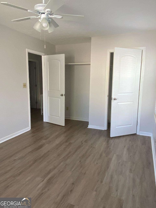 1304 Old Coach Rd SW, Marietta, GA 30008 - unfurnished bedroom with baseboards, wood finished floors, and a closet