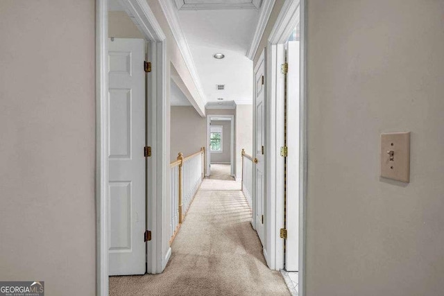 hallway featuring crown molding, visible vents, and light carpet