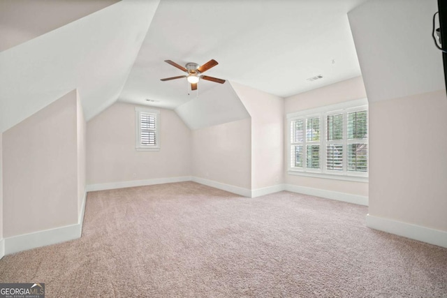 additional living space with carpet floors, baseboards, ceiling fan, and lofted ceiling
