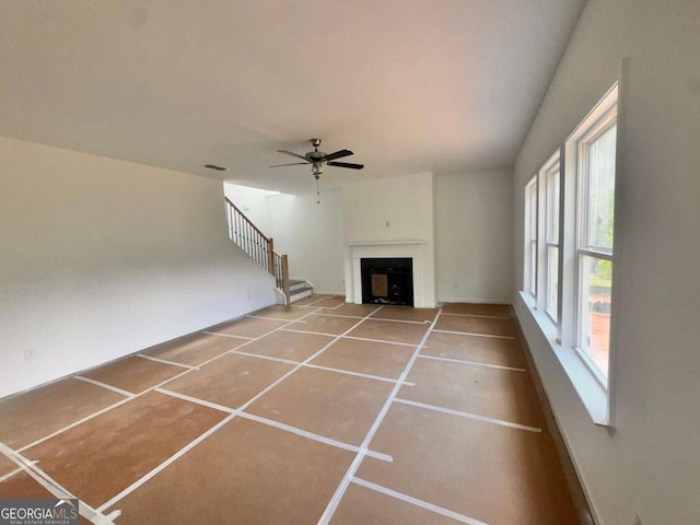 7252 Eton Ln, Locust Grove, GA 30248 - unfurnished living room with tile patterned flooring, a ceiling fan, a fireplace, and stairway