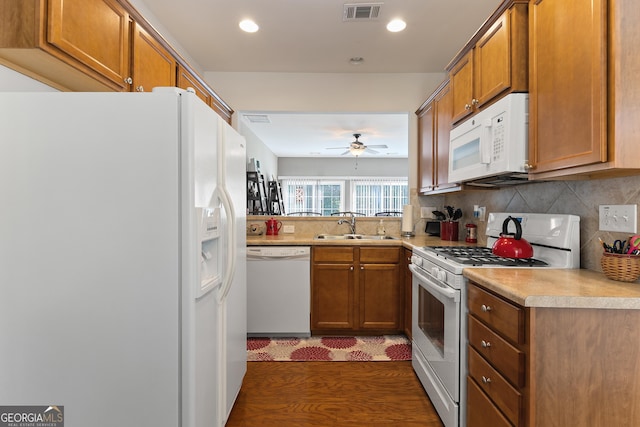 145 Begonia Ct, Griffin, GA 30223 - kitchen featuring white appliances, a sink, brown cabinets, a ceiling fan, and decorative backsplash