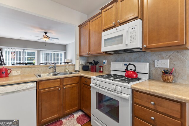 145 Begonia Ct, Griffin, GA 30223 - kitchen with white appliances, a sink, tasteful backsplash, and brown cabinetry