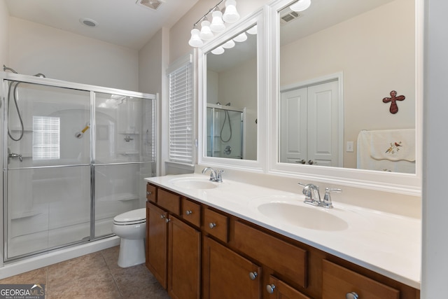 145 Begonia Ct, Griffin, GA 30223 - full bath with a stall shower, double vanity, toilet, and tile patterned flooring