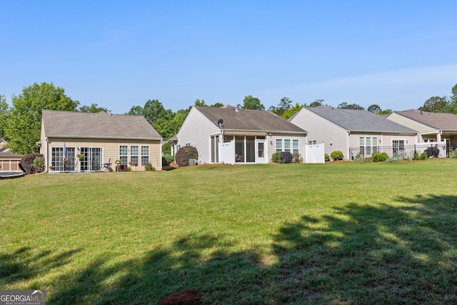 145 Begonia Ct, Griffin, GA 30223 - back of house with a lawn and a sunroom