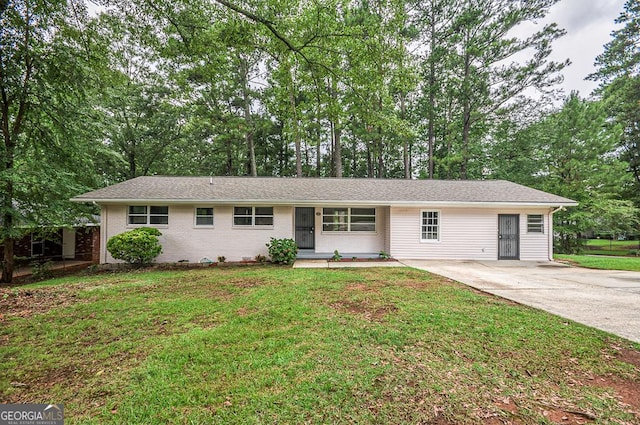 ranch-style home with brick siding, a front lawn, and concrete driveway