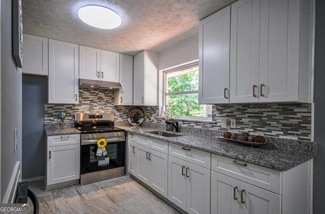 kitchen featuring a sink, under cabinet range hood, a textured ceiling, and stainless steel electric range