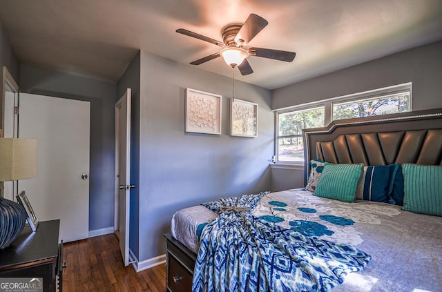 bedroom with a ceiling fan, wood finished floors, and baseboards