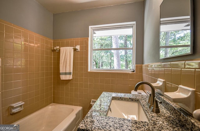 full bathroom featuring wainscoting, vanity, tub / shower combination, and tile walls